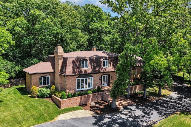 9216 Matthews Ln, Sunset Hills, MO 63127 - dutch colonial with brick siding, a chimney, a front yard, and a shingled roof
