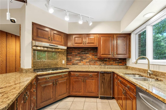 9216 Matthews Ln, Sunset Hills, MO 63127 - kitchen with appliances with stainless steel finishes, a sink, under cabinet range hood, light stone counters, and light tile patterned floors