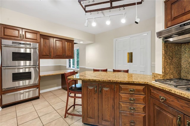 9216 Matthews Ln, Sunset Hills, MO 63127 - kitchen with a warming drawer, double oven, tasteful backsplash, under cabinet range hood, and a peninsula