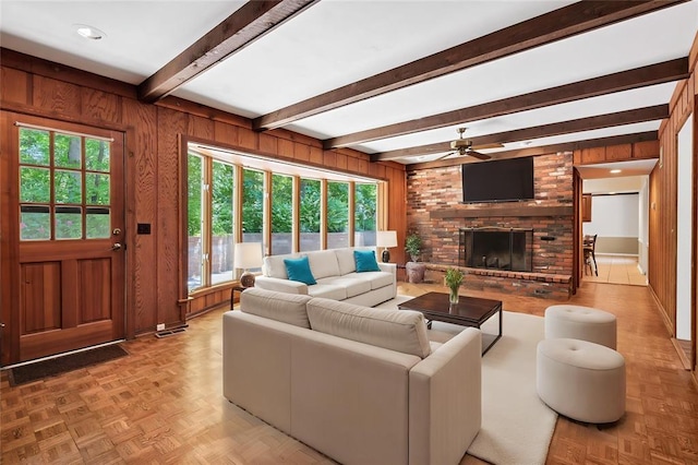 9216 Matthews Ln, Sunset Hills, MO 63127 - living room featuring ceiling fan, a brick fireplace, beam ceiling, and wood walls