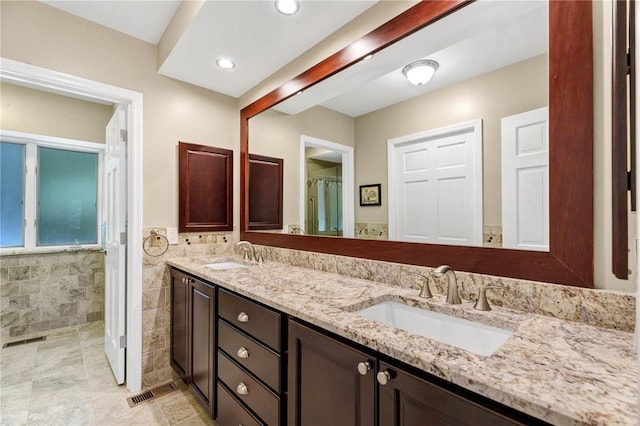 9216 Matthews Ln, Sunset Hills, MO 63127 - full bath with double vanity, a shower, tile walls, and recessed lighting