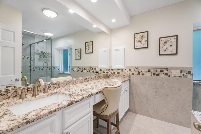 9216 Matthews Ln, Sunset Hills, MO 63127 - bathroom with tile walls, a shower stall, double vanity, a wainscoted wall, and recessed lighting