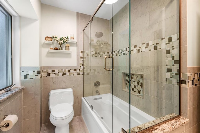 9216 Matthews Ln, Sunset Hills, MO 63127 - full bath featuring tile walls, bath / shower combo with glass door, toilet, and tile patterned flooring