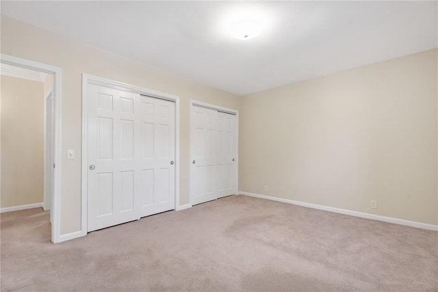 9216 Matthews Ln, Sunset Hills, MO 63127 - unfurnished bedroom with carpet, multiple closets, and baseboards
