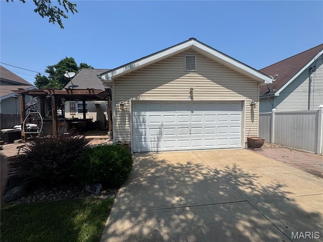2828 Rutger St, Saint Louis, MO 63104 - view of front of home with a pergola, an outdoor structure, a garage, and driveway