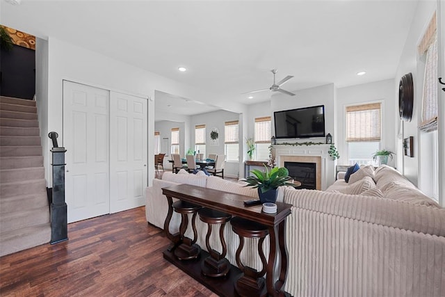 1017 Kilderkin Way, Saint Charles, MO 63301 - living area with dark wood-style floors, ceiling fan, stairway, a glass covered fireplace, and recessed lighting