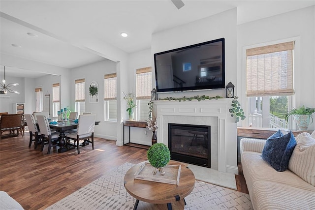 1017 Kilderkin Way, Saint Charles, MO 63301 - living room with wood finished floors, a fireplace, baseboards, recessed lighting, and a chandelier