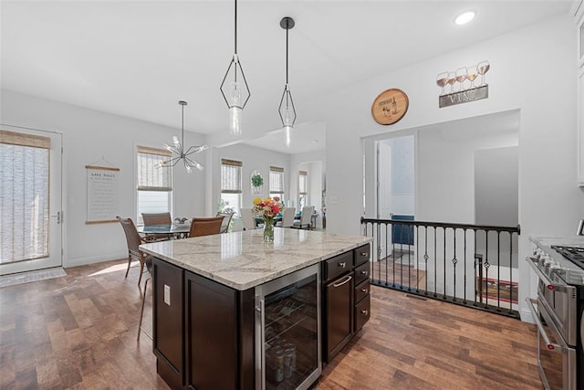 1017 Kilderkin Way, Saint Charles, MO 63301 - kitchen with wine cooler, dark wood-type flooring, double oven range, a chandelier, and hanging light fixtures