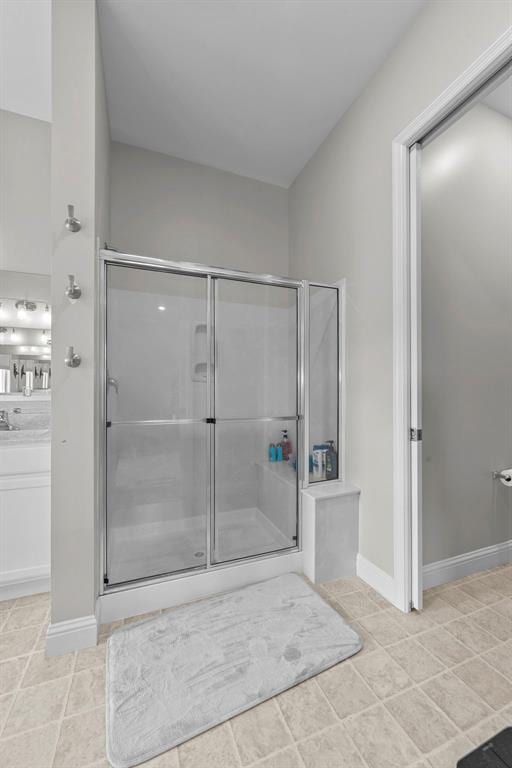 1017 Kilderkin Way, Saint Charles, MO 63301 - full bathroom with a stall shower, baseboards, and tile patterned floors