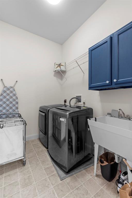 1017 Kilderkin Way, Saint Charles, MO 63301 - laundry area with washer and clothes dryer, cabinet space, and baseboards