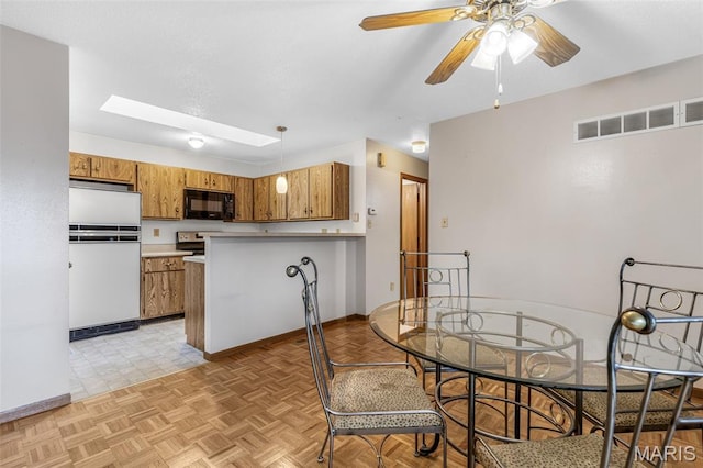 101 Carnegie Ct, Valley Park, MO 63088 - dining room featuring ceiling fan, baseboards, and a skylight