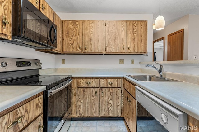 101 Carnegie Ct, Valley Park, MO 63088 - kitchen featuring stainless steel range with electric cooktop, black microwave, dishwasher, a sink, and light countertops