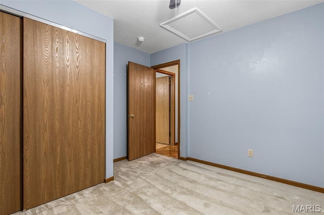 101 Carnegie Ct, Valley Park, MO 63088 - unfurnished bedroom with light carpet, a closet, attic access, and baseboards