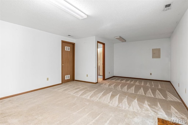 101 Carnegie Ct, Valley Park, MO 63088 - unfurnished room with light colored carpet, a textured ceiling, baseboards, and electric panel