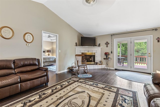 303 Holly Tree Ln, Farmington, MO 63640 - living room featuring lofted ceiling, hardwood / wood-style floors, a tiled fireplace, a ceiling fan, and baseboards