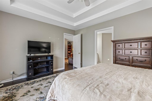 303 Holly Tree Ln, Farmington, MO 63640 - bedroom with dark wood-type flooring, a raised ceiling, baseboards, and ceiling fan