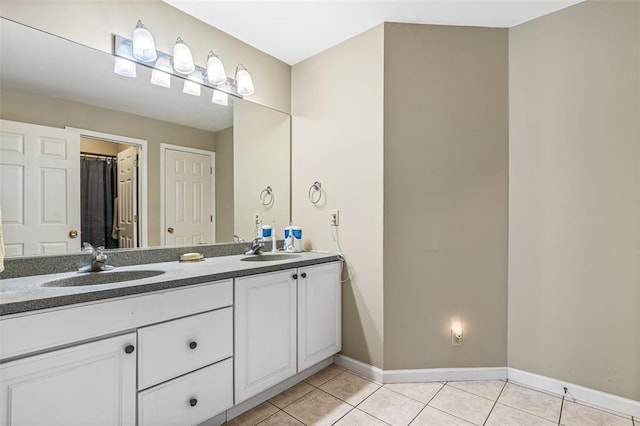 303 Holly Tree Ln, Farmington, MO 63640 - full bath with tile patterned flooring, double vanity, and baseboards