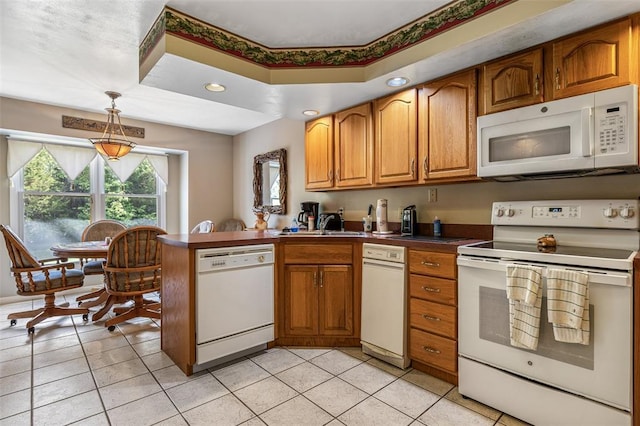 303 Holly Tree Ln, Farmington, MO 63640 - kitchen with white appliances, a peninsula, brown cabinetry, light tile patterned floors, and recessed lighting