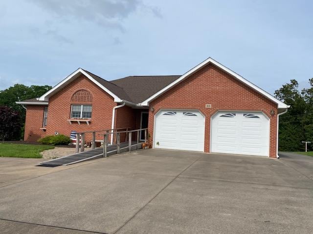 28 Spring Lake Rd, Perryville, MO 63775 - single story home with driveway, an attached garage, and brick siding