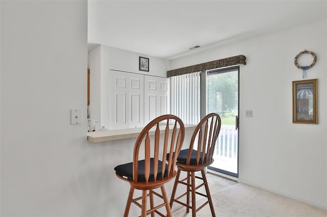 1306 Glendale Gardens Dr Unit C, Glendale, MO 63122 - dining space featuring light colored carpet and baseboards