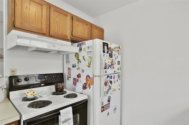 1306 Glendale Gardens Dr Unit C, Glendale, MO 63122 - kitchen with electric stove, under cabinet range hood, brown cabinets, light countertops, and freestanding refrigerator