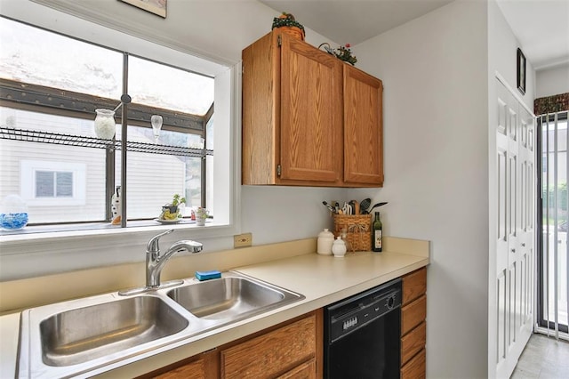 1306 Glendale Gardens Dr Unit C, Glendale, MO 63122 - kitchen with black dishwasher, a sink, brown cabinets, and healthy amount of natural light