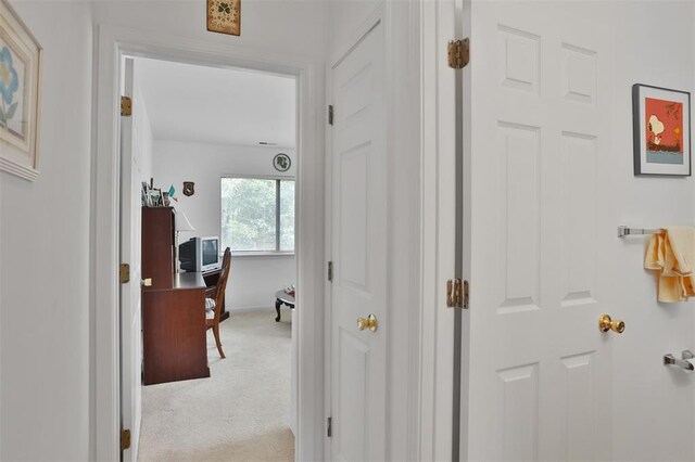 1306 Glendale Gardens Dr Unit C, Glendale, MO 63122 - hallway featuring light colored carpet, baseboards, and a desk