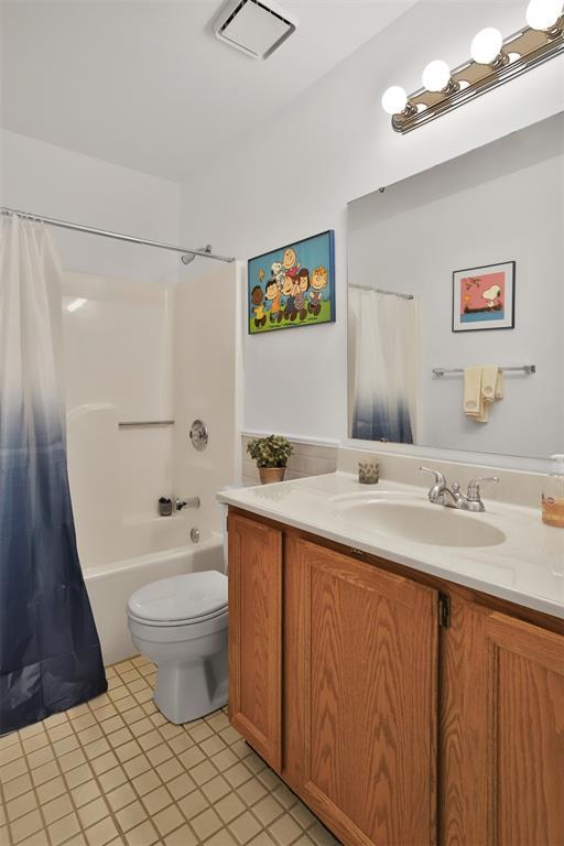 1306 Glendale Gardens Dr Unit C, Glendale, MO 63122 - full bathroom featuring tile patterned flooring, toilet, vanity, and shower / bathtub combination with curtain