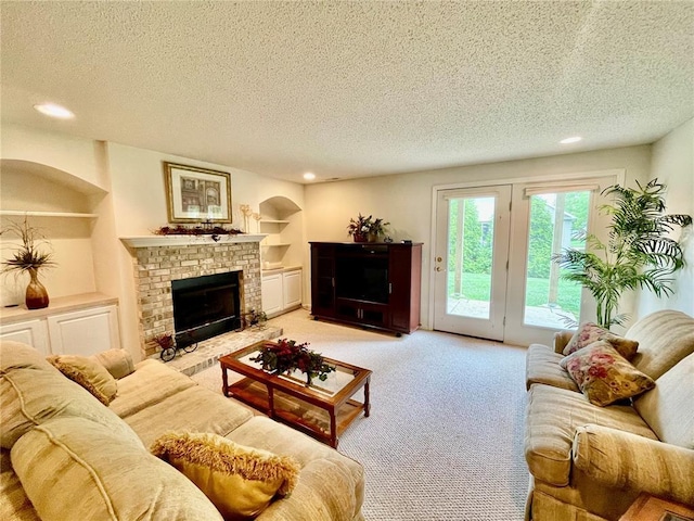 2087 Hawks Landing Dr Unit S, Lake St Louis, MO 63367 - living room featuring a fireplace, a textured ceiling, light colored carpet, recessed lighting, and built in features