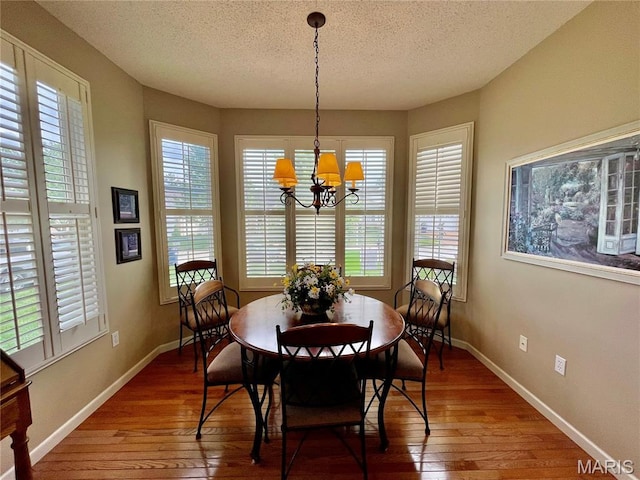 2087 Hawks Landing Dr, Lake St Louis, MO 63367 - dining area featuring hardwood / wood-style flooring, a chandelier, and a textured ceiling
