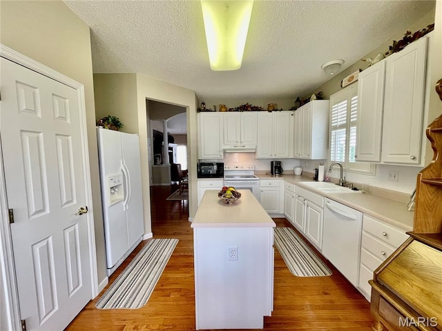 2087 Hawks Landing Dr, Lake St Louis, MO 63367 - kitchen featuring white appliances, a center island, a textured ceiling, white cabinets, and light wood finished floors