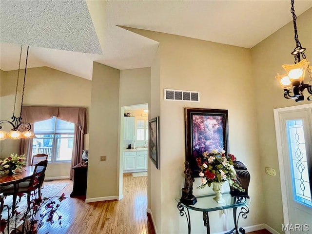 2087 Hawks Landing Dr, Lake St Louis, MO 63367 - foyer entrance with a chandelier, light wood-style floors, and vaulted ceiling