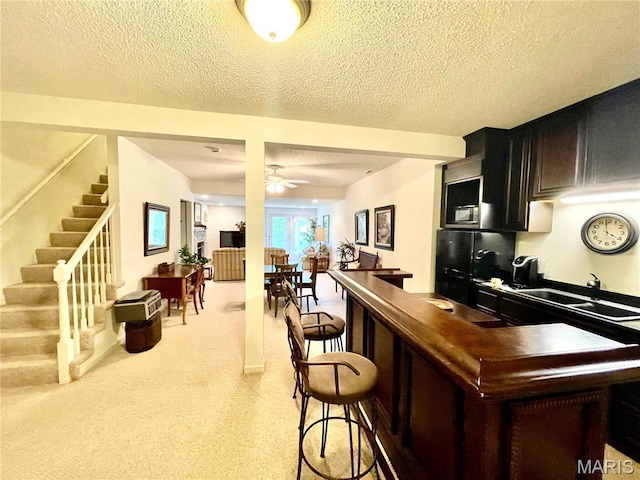 2087 Hawks Landing Dr, Lake St Louis, MO 63367 - kitchen with a textured ceiling, ceiling fan, light carpet, and freestanding refrigerator