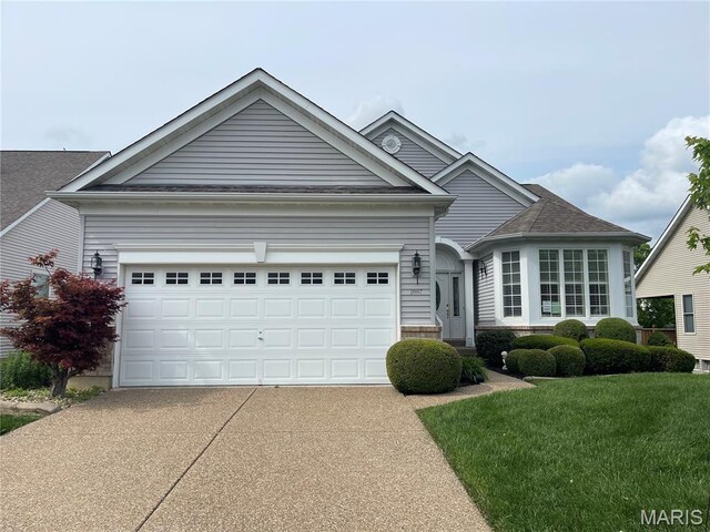 2087 Hawks Landing Dr, Lake St Louis, MO 63367 - view of front of home with concrete driveway, an attached garage, and a front lawn