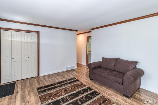 2915 Ozark Dr, Queeny Township, MO 63122 - living area featuring wood finished floors, baseboards, and ornamental molding