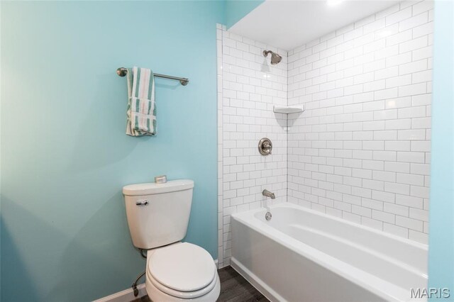 2915 Ozark Dr, Queeny Township, MO 63122 - bathroom featuring toilet, tub / shower combination, wood finished floors, and baseboards