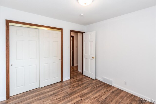 2915 Ozark Dr, Queeny Township, MO 63122 - unfurnished bedroom featuring wood finished floors, a closet, and baseboards