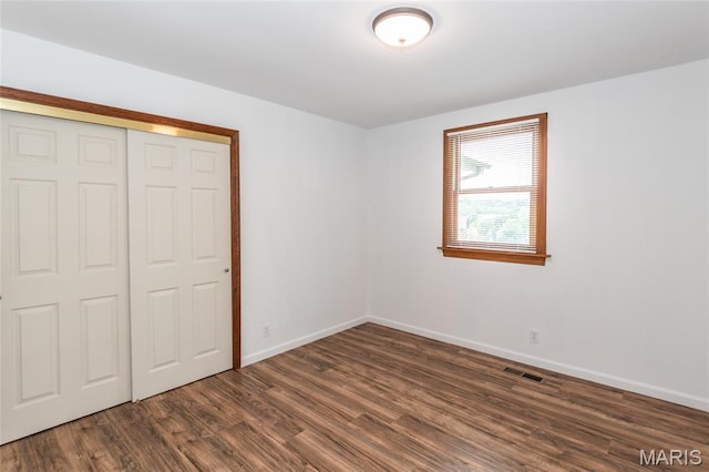 2915 Ozark Dr, Queeny Township, MO 63122 - unfurnished bedroom featuring dark wood-type flooring, baseboards, and a closet