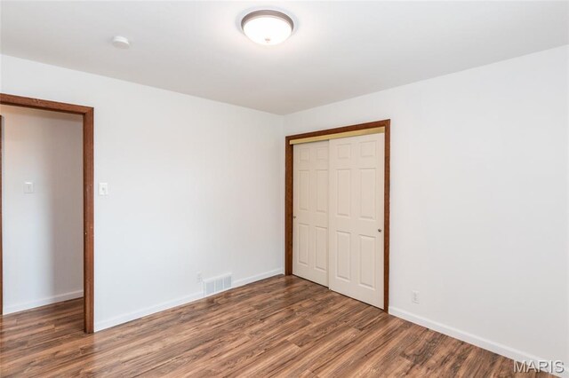 2915 Ozark Dr, Queeny Township, MO 63122 - unfurnished bedroom with wood finished floors, a closet, and baseboards