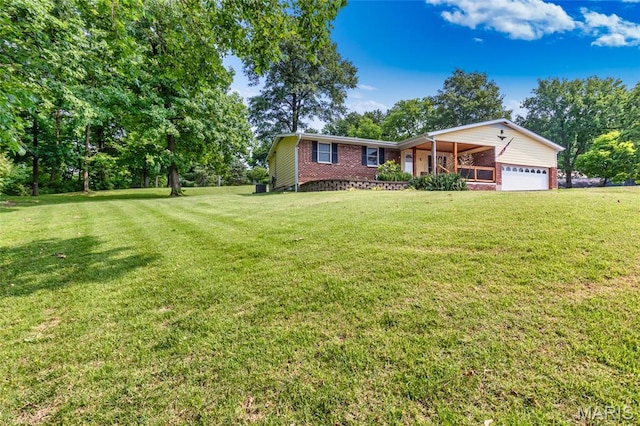 2915 Ozark Dr, Queeny Township, MO 63122 - view of front of home featuring brick siding, an attached garage, and a front yard