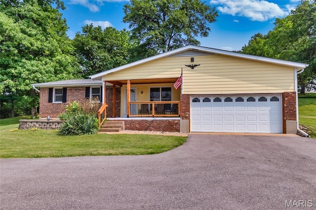 2915 Ozark Dr, Queeny Township, MO 63122 - ranch-style house featuring brick siding, covered porch, driveway, a front lawn, and a garage