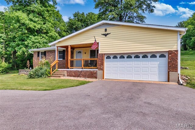 2915 Ozark Dr, Queeny Township, MO 63122 - single story home featuring brick siding, driveway, covered porch, and an attached garage