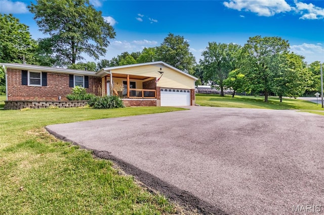 2915 Ozark Dr, Queeny Township, MO 63122 - ranch-style house featuring brick siding, a porch, an attached garage, driveway, and a front lawn