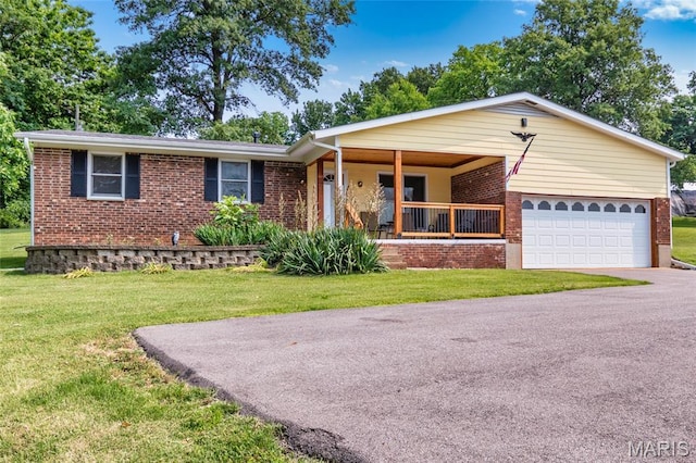 2915 Ozark Dr, Queeny Township, MO 63122 - ranch-style home featuring brick siding, a porch, a front lawn, and an attached garage