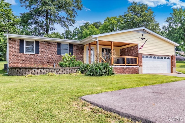 2915 Ozark Dr, Queeny Township, MO 63122 - ranch-style home with brick siding, a front yard, an attached garage, driveway, and covered porch