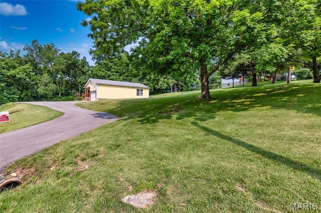 2915 Ozark Dr, Queeny Township, MO 63122 - view of green lawn with a detached garage