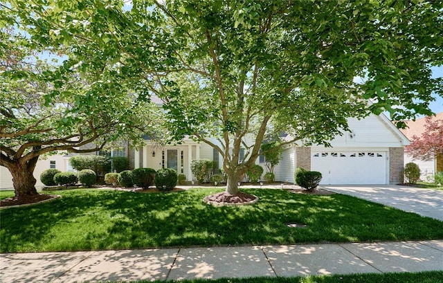 2529 Maple Tree Dr, Saint Charles, MO 63303 - view of property hidden behind natural elements featuring concrete driveway, brick siding, and a front yard