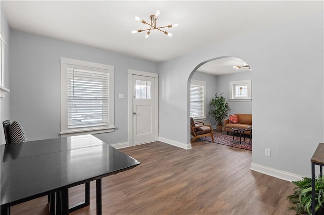 6927 Lansdowne Ave, Saint Louis, MO 63109 - entryway featuring arched walkways, a chandelier, healthy amount of natural light, and wood finished floors