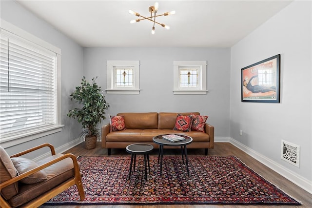 6927 Lansdowne Ave, Saint Louis, MO 63109 - living room with a chandelier, wood finished floors, and baseboards