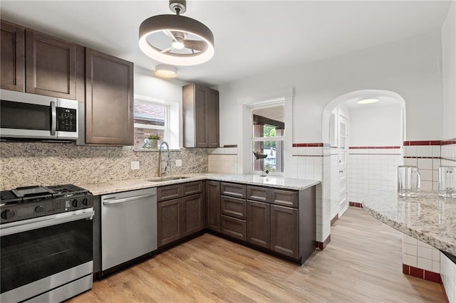6927 Lansdowne Ave, Saint Louis, MO 63109 - kitchen with appliances with stainless steel finishes, a sink, plenty of natural light, light wood finished floors, and tile walls